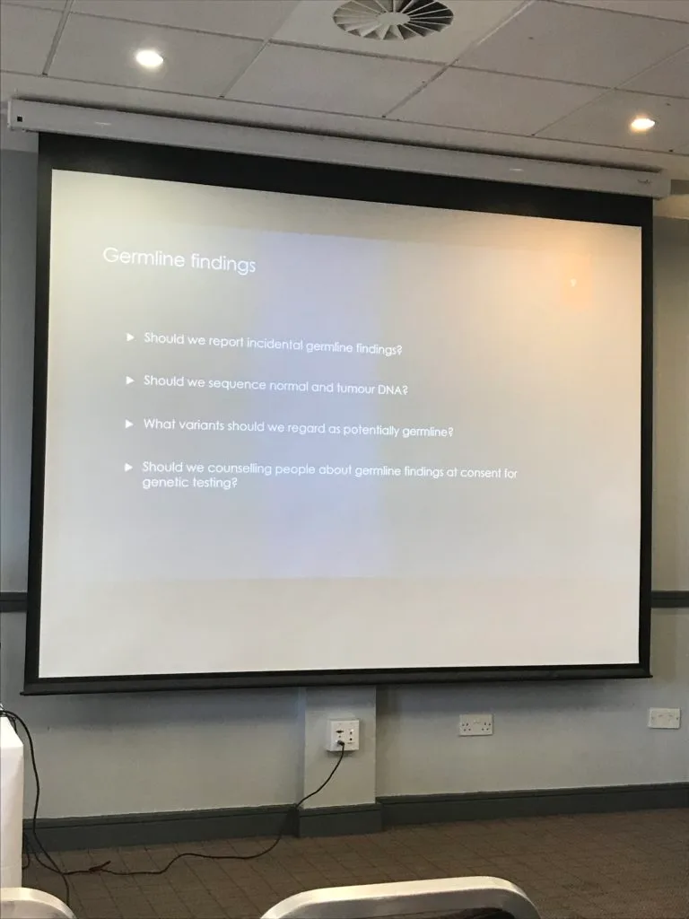 A conference slide headed Germline findings, listing questions about reporting germline results found during tumour testing.