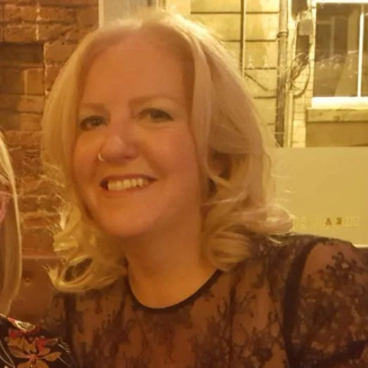 Beth Roberts smiling, photographed indoors.